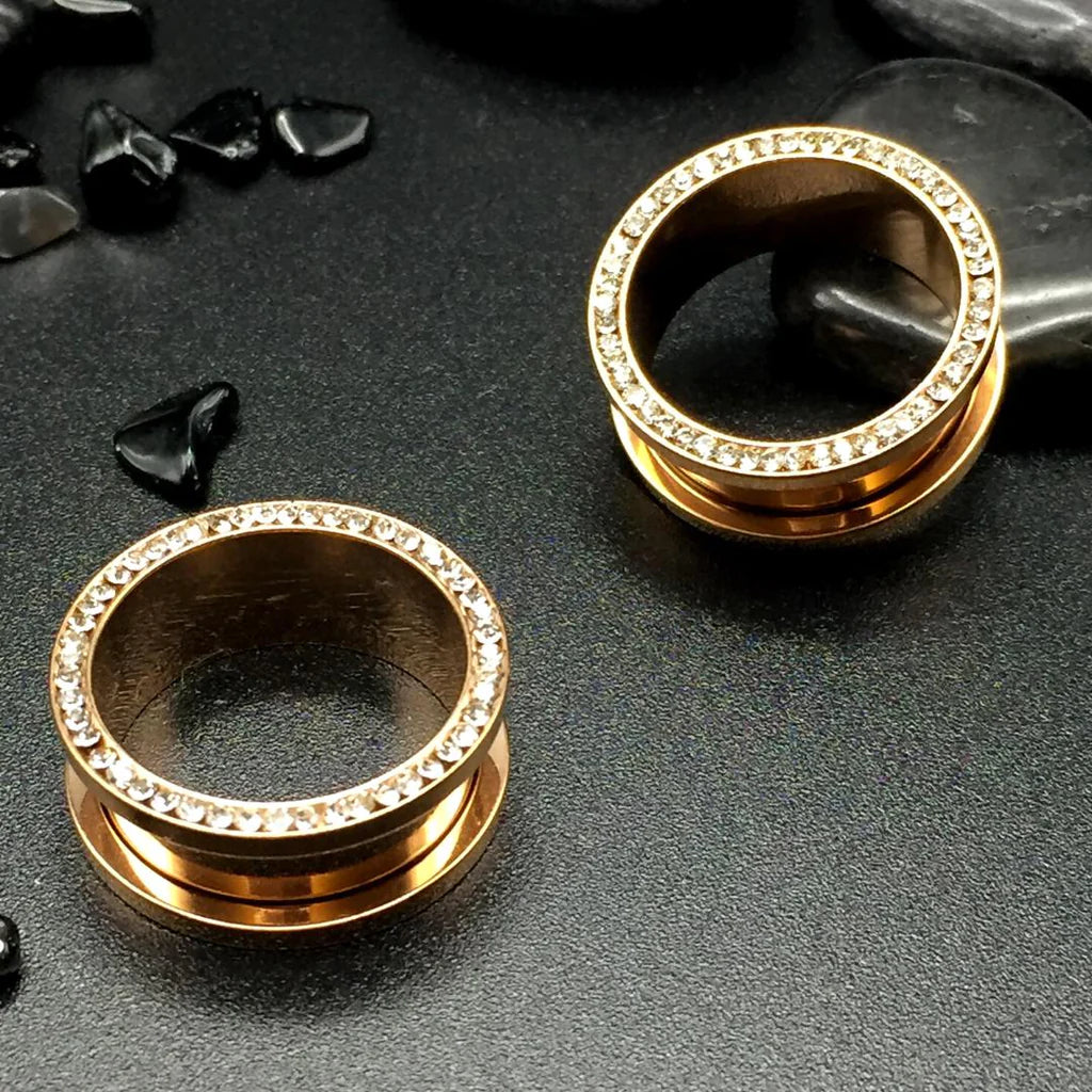 Lustrous rose gold steel tunnels, accentuated with inner gems. Where charm meets glitz.