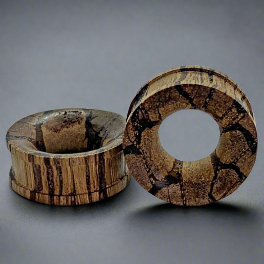 a pair of root wood tunnels for stretched ears