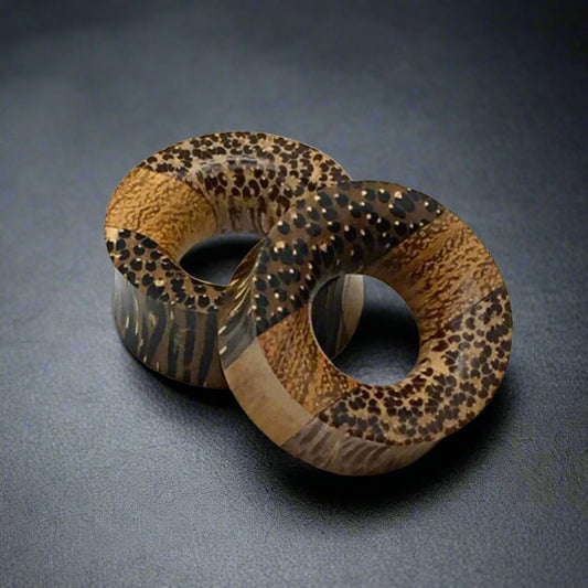 a pair of tri wood tunnels for stretched ears